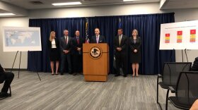 William McSwain, center, at Tuesday's presser. 