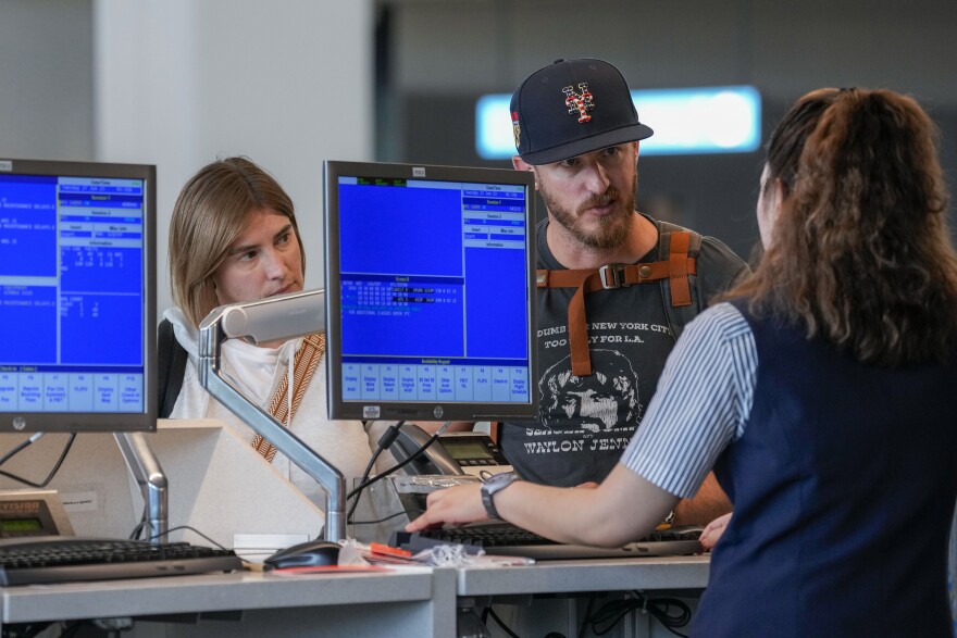 An airline agent helps travelers in the departures area of Terminal B at LaGuardia Airport, Tuesday, June 27, 2023, in New York. The U.S. Department of Transportation said Tuesday, April 16, 2024, that it will give the states power to investigate complaints about airlines and ticket sellers, and then refer cases to the federal government for enforcement. (AP Photo/Mary Altaffer, File)