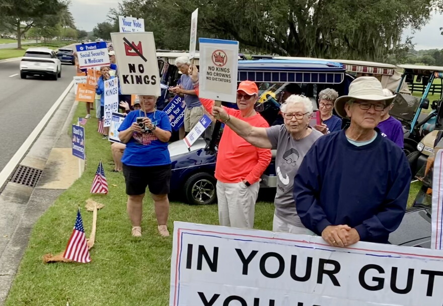 A crowd of mostly senior citizens lined County Road 466A in The Villages for a No Kings protest Saturday morning.