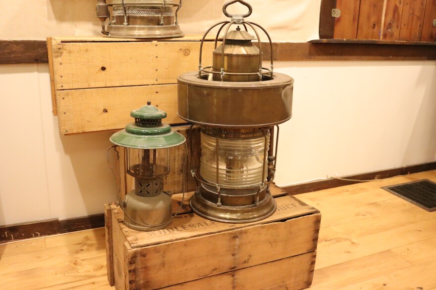 Modern-day camping lantern, left, compared to historic navigation lantern