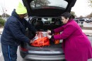 From left, Del Valle residents Richard Franklin and Rebecca Birch pull open their cooler showing groceries they purchased at the Mueller HEB in Austin.