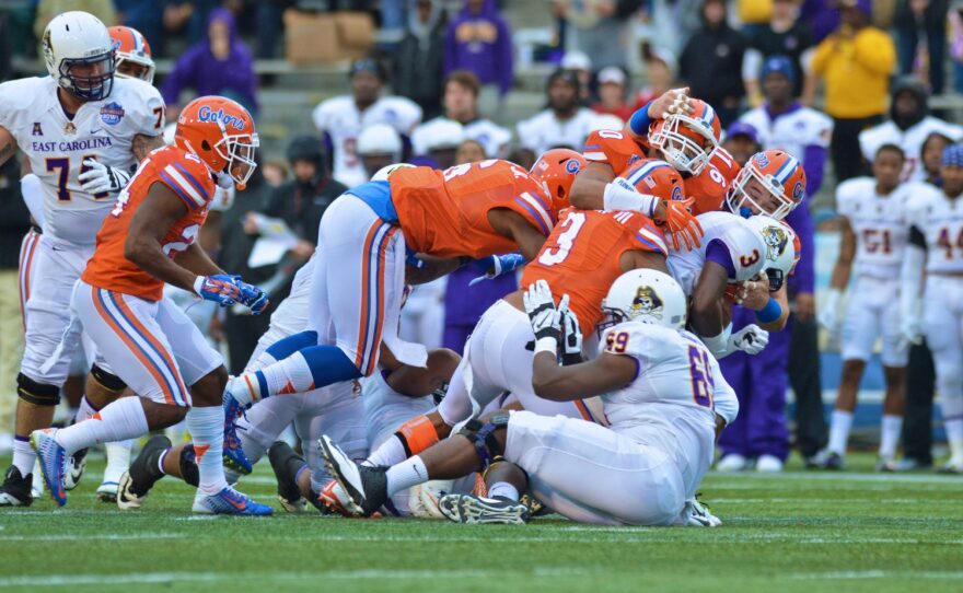A swarm of Gator defenders bring down ECU running back Anthony Scott.