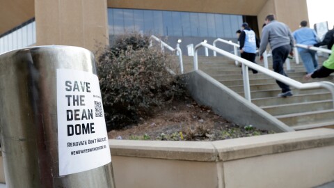 North Carolina fans file into the building beside a "Save the Dean Dome" sticker before an NCAA college basketball game against Clemson, Tuesday, March 3, 2026, in Chapel Hill, N.C.