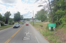google streetview of a road with cars and a Hamden village sign.