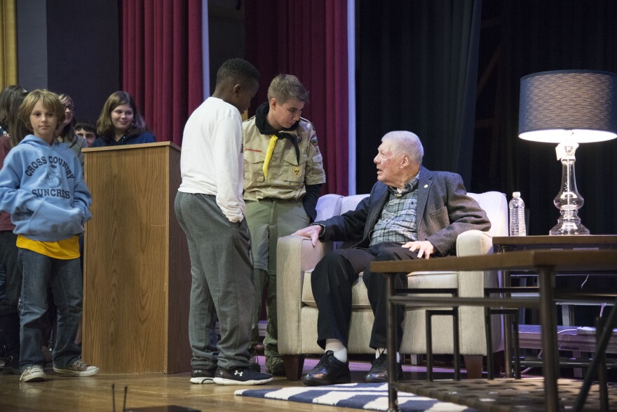 Seaman 1st Class Richard Cunningham speaks with students following a talk he gave at the Morgantown High School auditorium on Monday, Nov. 9.