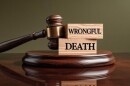 Wooden Gavel And Blocks Spelling Wrongful Death on Wooden Table Concept Image