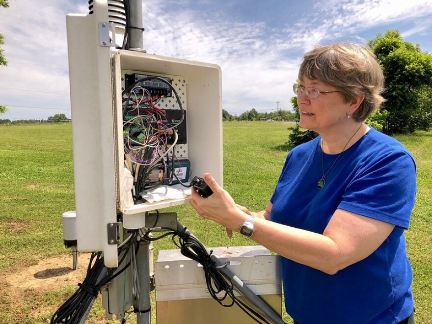 Climatologist Pam Knox with a weather station.