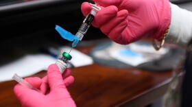 FILE - Anna Hicks prepares a measles, mumps and rubella vaccine at the Andrews County Health Department, Tuesday, April 8, 2025, in Andrews, Texas.