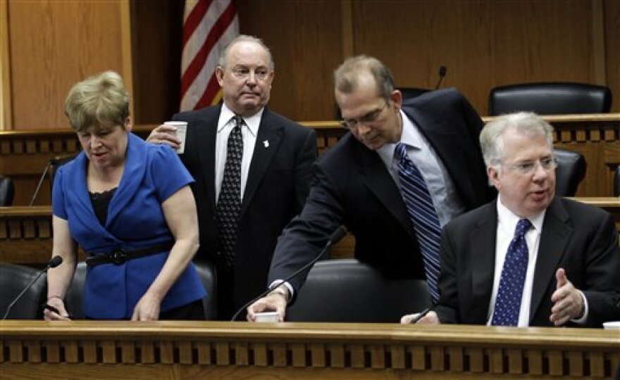 From left, Sen. Lisa Brown, D-Spokane, Sen. Mike Hewitt, R-Walla Walla, Sen. Joe Zarelli, R-Ridgefield, and Sen. Ed Murray, D-Seattle, take their seats to talk about a tentative budget agreement, Tuesday in Olympia.