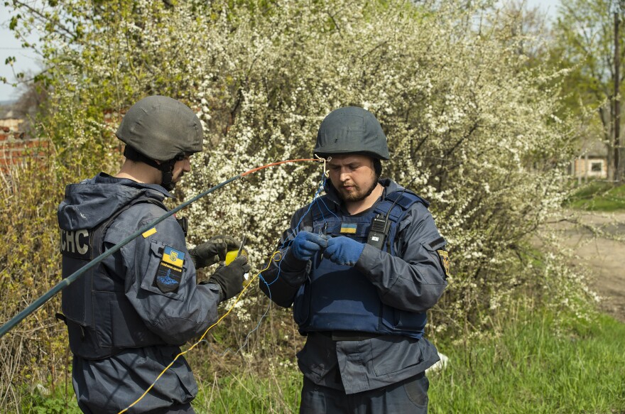 Kharkiv EOD technician Maksim affixes a C-4 charge to its firing point in preparation for detonating the first of the mines.