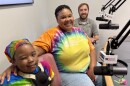 Amaneigh Stevenson, 7, left, recently finished treatment for Hodgkin's Lymphoma. Mom Karisma Morris-Bush, center, said their experience redefined her family's experience with cancer after losing her mother to cancer before her children were born. Recognizing the need for kids to have a way to stay active without fear of harming their chest ports, OSF exercise physiologist Nick Kemp designed a port guard which Amaneigh piloted during her treatment.