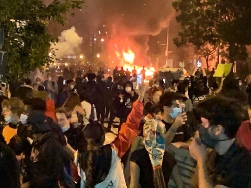 A car apparently set on fire by protesters burns near the White House Sunday night.