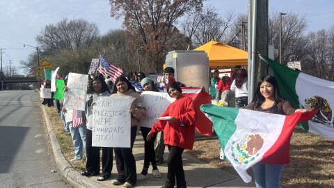 Protesters carry signs and flags 