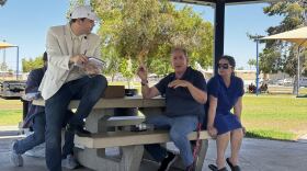 Carlos Adams meets with Yuma residents under Kennedy Park ramada.