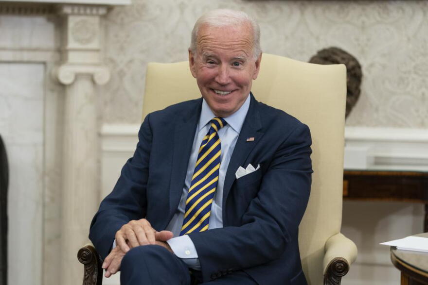 FILE - President Joe Biden smiles in the Oval Office of the White House, Sept. 16, 2022, in Washington. The White House is reaching out to local governments. It's hosting officials from North Carolina on Thursday to highlight funding opportunities and hear firsthand how coronavirus relief, infrastructure dollars and other policies are faring in communities.