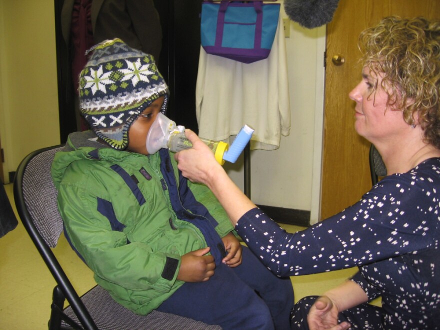 Kathy Harvey of the Zigler Head Start Center in New Haven, Conn., gives 4-year-old student Anthony Hebert an asthma treatment.