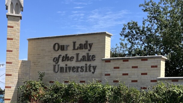 A tan brick sign that says Our Lady of the Lake University in brown letters/