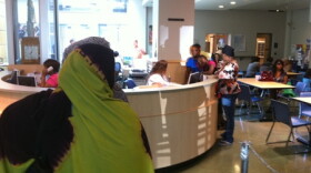 Parents and their kids line-up for registration at Seattle School District headquarters last June, prior to the school year.