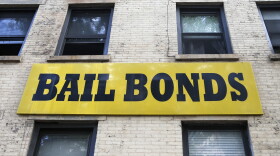 A bail bonds sign hangs on the side of a bail bonds business. (Kathy Willens/AP)