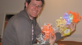 Artist Jesse Small takes photographs of trees and interprets their pattern into these pieces on display here. They'll attach to a hub to create a chandelier.