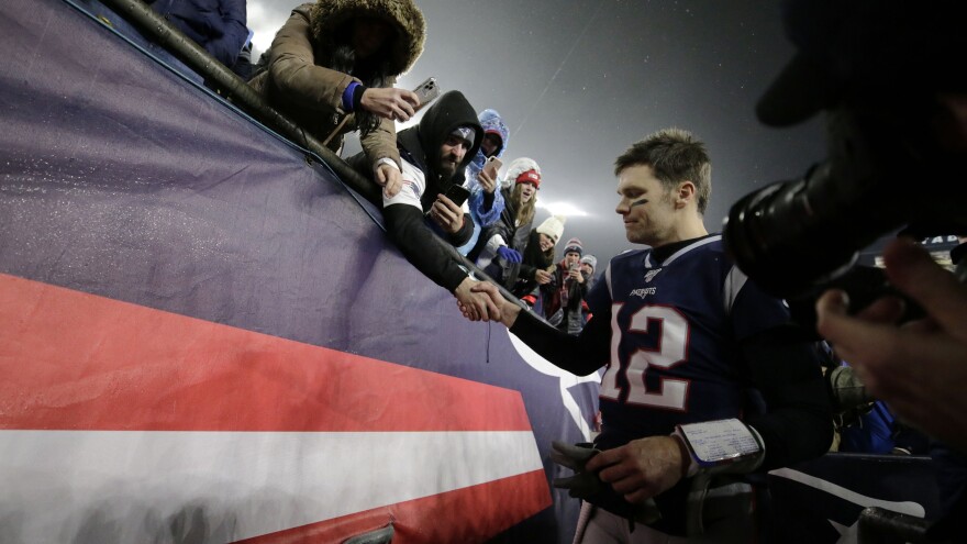 Tom Brady shakes hands with a fan as he leaves the field in Foxborough, Mass., after losing a playoff football game to the Tennessee Titans earlier this year. As it turns out, that was likely the final game the quarterback would play in a New England Patriots uniform. He announced his departure Tuesday.