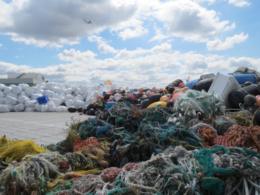 A football-field sized barge carries marine debris from Alaska and British Columbia. Scientists estimate the amount of marine debris increased at least 10-fold due to the 2011 Japan tsunami. (Photo by National Oceanic and Atmospheric Administration)