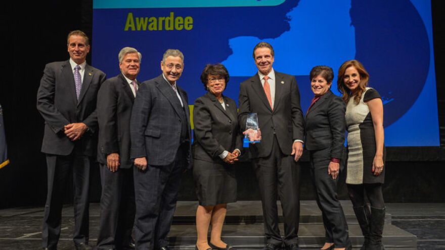 Governor Cuomo poses with some of the Regional Council awards winners in December 2014, along with former legislative leaders Sheldon Silver and Dean Skelos. Both Silver and Skelos have left their posts following corruption charges