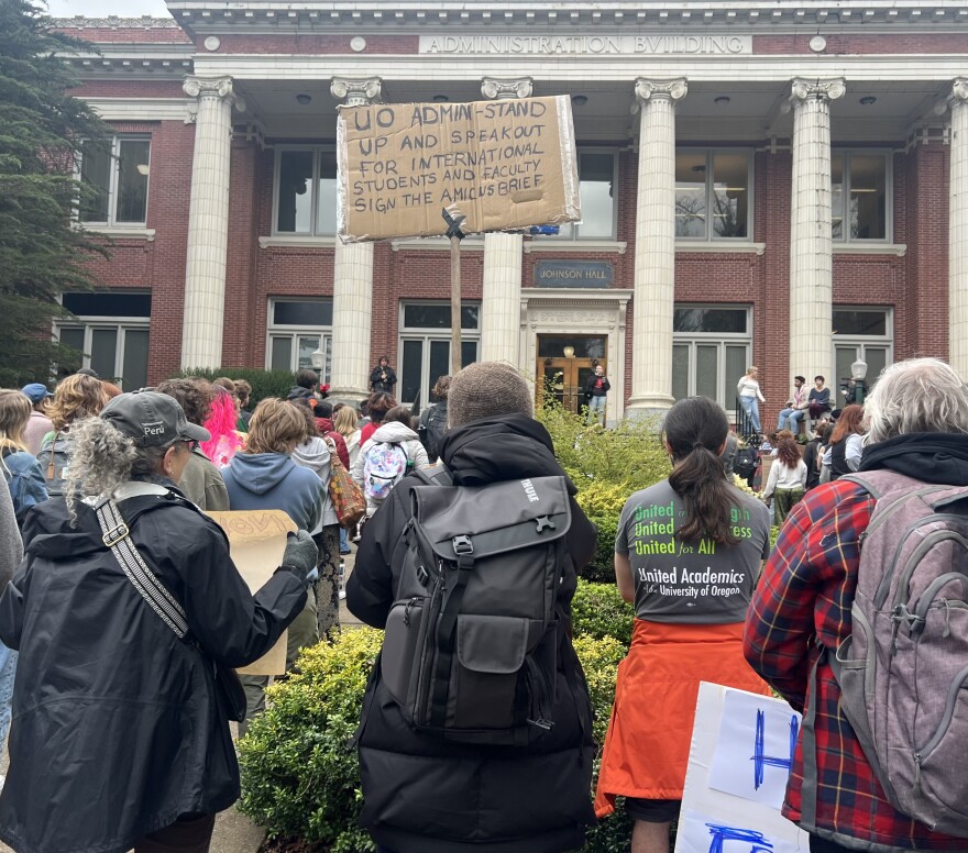 Supporters stand outside the UO Administration building during the rally