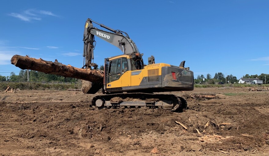 A BCI Contracting excavator moves logs into place as part of the habitat restoration. Working at the site was the company’s youngest equipment operator, 20, and its oldest, an 83-year-old who says he plans to work until he is 86 so he can be the oldest known operator.