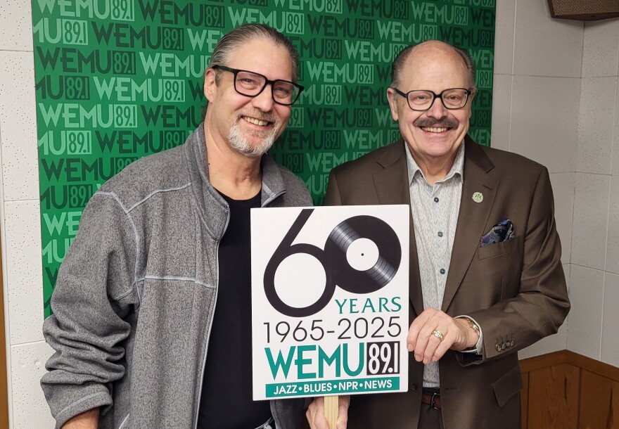 WEMU's David Fair (left) and EMU President Dr. James Smith celebrates WEMU's 60th anniversary at the WEMU studio.