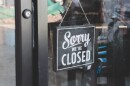 "We're closed" sign on the door of a business. Stock Photo