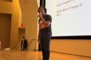 Woman speaking into a microphone on stage