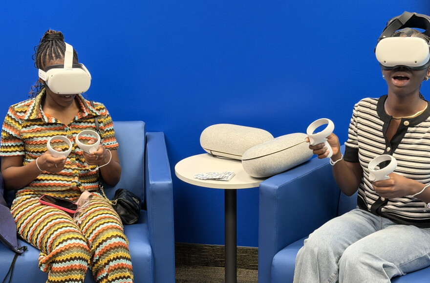 Two College of Central Florida students try out the virtual reality headsets at the grand opening of the new Center for Career Development on Tuesday, Sept. 22, 2026. (Jake Hoffman/WUFT News)