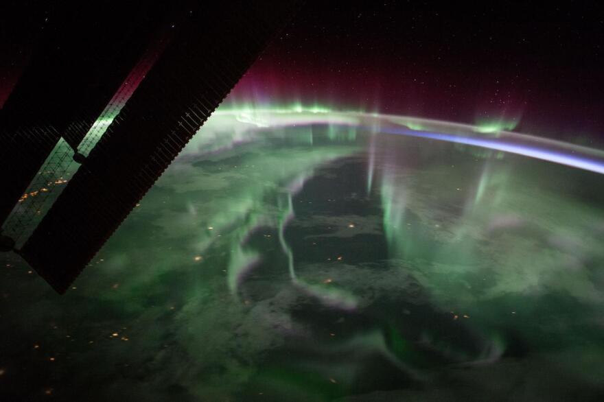 The spectacular aurora borealis, or the “northern lights,” over Canada is sighted from the space station near the highest point of its orbital path. The station’s main solar arrays are seen in the left foreground.