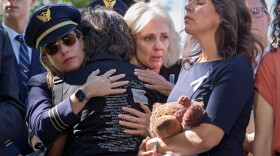 National Transportation Safety Board Chair Jennifer Homendy, center, helps to comfort Christina Stovall, center with back to camera, and Laura Augendre, right, family members of victims of flight 5342, the deadly Jan. 2025 midair collision between an American Airlines plane and a Black Hawk helicopter over the Potomac River, during a news conference on air safety reforms, at the Capitol in Washington, Tuesday, Sept. 15, 2026.
