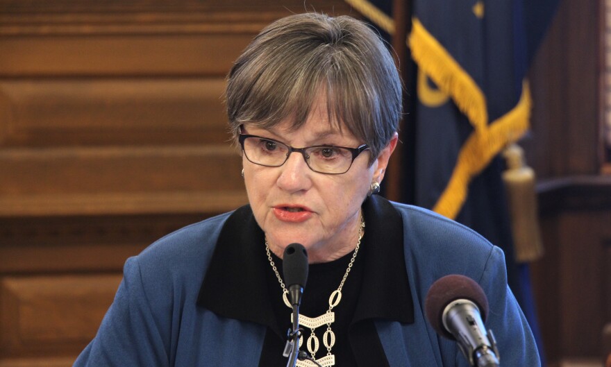  Kansas Gov. Laura Kelly signed a K-12 spending bill but vetoed a portion that could cut funding to about 100 rural school districts.