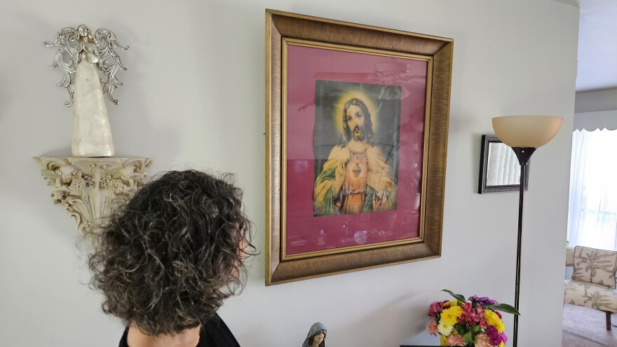 "Inez" looks at artwork her great grandmother brough to the family
