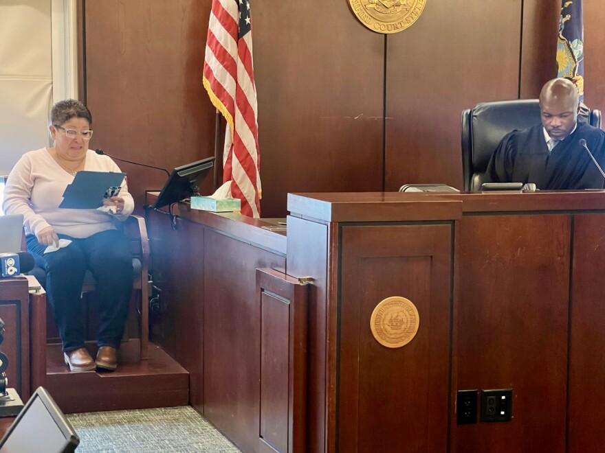 Lisa Schmitt delivers an impact statement to Judge Little on March 20, 2026