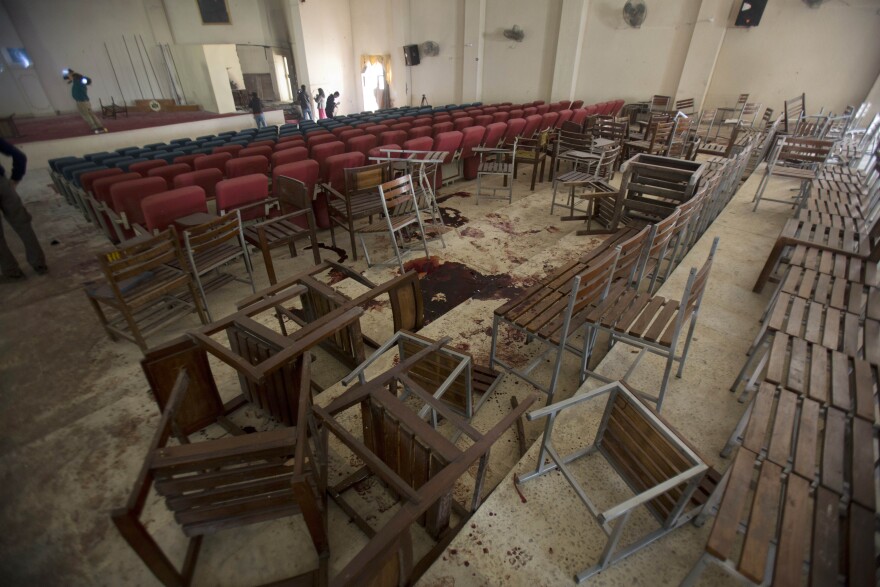 Chairs are upturned and blood stains the floor at the Army Public School auditorium the day after Taliban gunmen stormed the school in Peshawar, Pakistan.