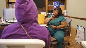 Head nurse Francia Webb talks to a client about abortion options at the West Alabama Women's Center in Tuscaloosa, Ala., on Monday, March 14, 2022. Webb says her experience suffering a miscarriage at five months has given her "a testimony" that she can share with clients considering ending a pregnancy. "By working here, I feel like it's like a blessing. Because I can minister and talk to people in all different kinds of ways, other than just abortion." (AP Photo/Allen G. Breed)