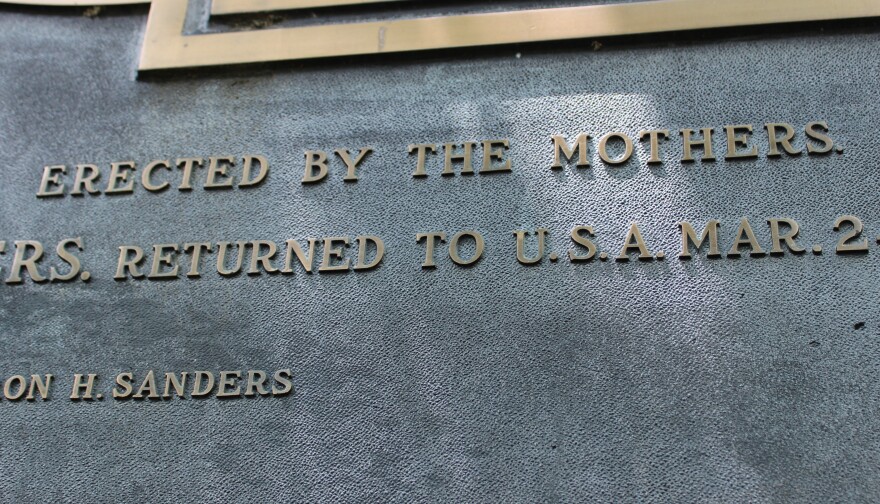 Raised letters on a metal plaque read "erected by the mothers."