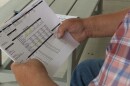 A man holds a sheet of paper