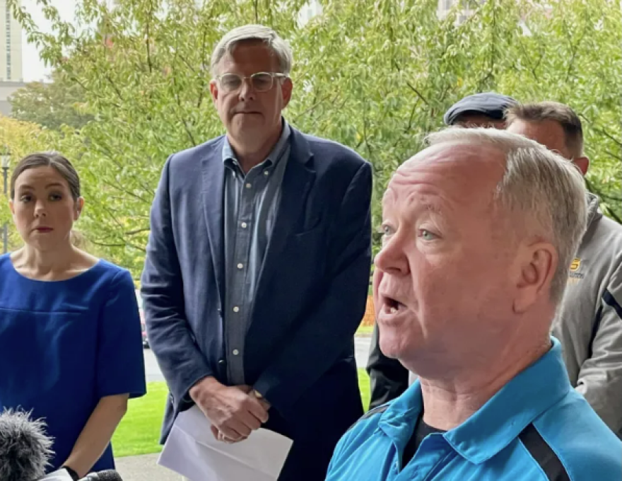 Bob Stefanowski listening to John Krupinsky, president of the Fraternal Order of Police. At left is Kris O’Donnell, the wife of an injured police officer.