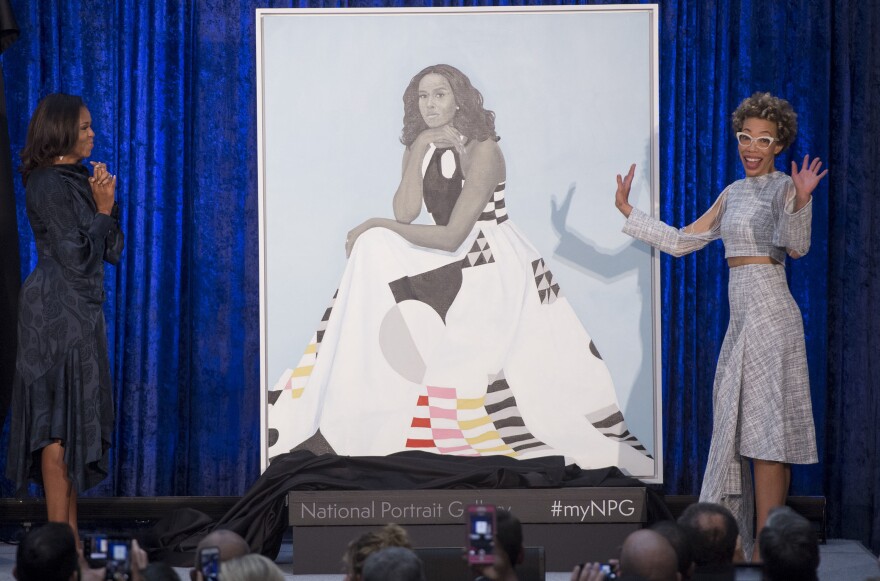 Former First Lady Michelle Obama (L) and artist Amy Sherald (R) unveil Mrs. Obama's portrait at the Smithsonian's National Portrait Gallery.