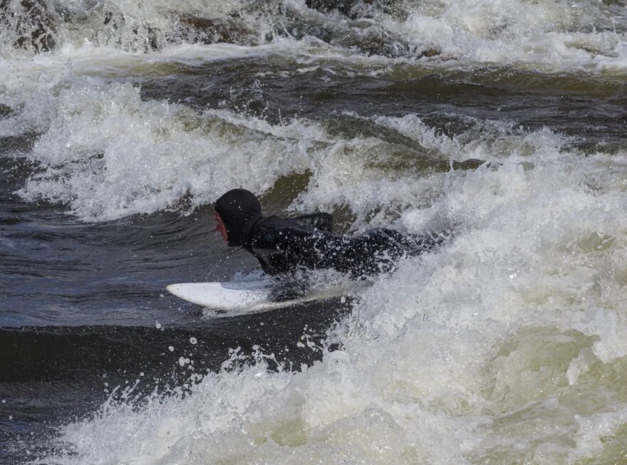 Alex Norton of Crested Butte surfs a rapid in the Gunnison whitewater park on his paddleboard.
