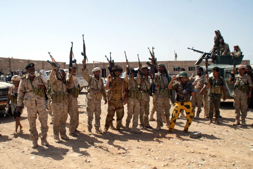 Yemeni soldiers hold up their weapons at an area seized from al-Qaida in the southeastern province of Shabwa, Yemen, on May 8. President Obama said Wednesday that U.S. strategy against the so-called Islamic State would be similar to how it targeted militants in Yemen and Somalia.