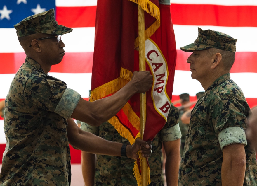 U.S. Marine Corps Col. Richard D. Marshall Jr., oncoming commanding officer, Marine Corps Base Camp Blaz, takes the command colors from Col. Ernest Govea, outgoing commanding officer, MCB Camp Blaz, during a change of command ceremony on MCB Camp Blaz, Guam, July 17, 2025.