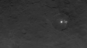 A cluster of mysterious bright spots on dwarf planet Ceres can be seen in this image, taken by NASA's Dawn spacecraft.
