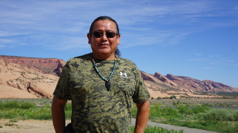 Raymond Peaches stands near where one proposed hydropower project might one day sit on the Navajo Nation. Critics of the project point to questionable tactics used by the developer and his allies as they advocate for the facility.