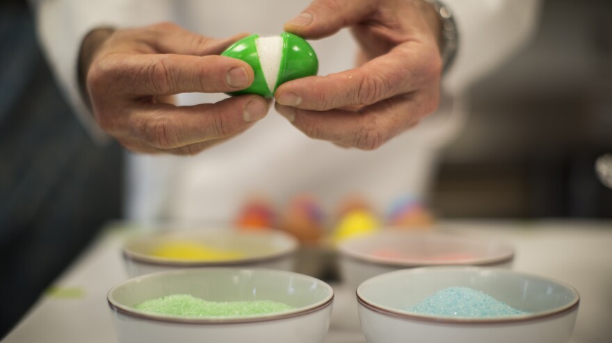 After the marshmallow has set, open the plastic shell and dip the egg in flavored and colored sugar, as Thomas Keller demonstrates here.